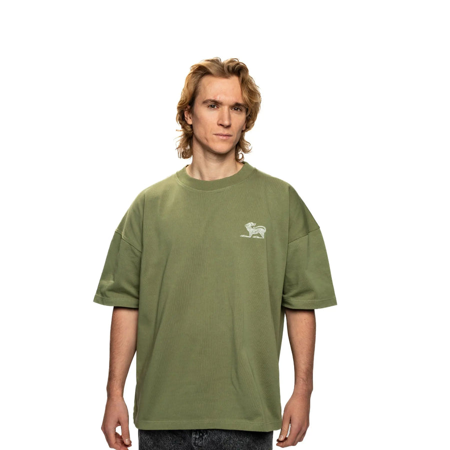 Person wearing a green t-shirt with a small logo on a white background