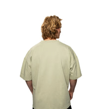 Person wearing a beige t-shirt on a white background