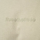 Beige fabric with 'ThreefiveThree' branding