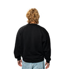 Person wearing a black sweatshirt on a white background