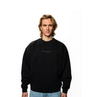 Person wearing a black sweatshirt with text on a white background