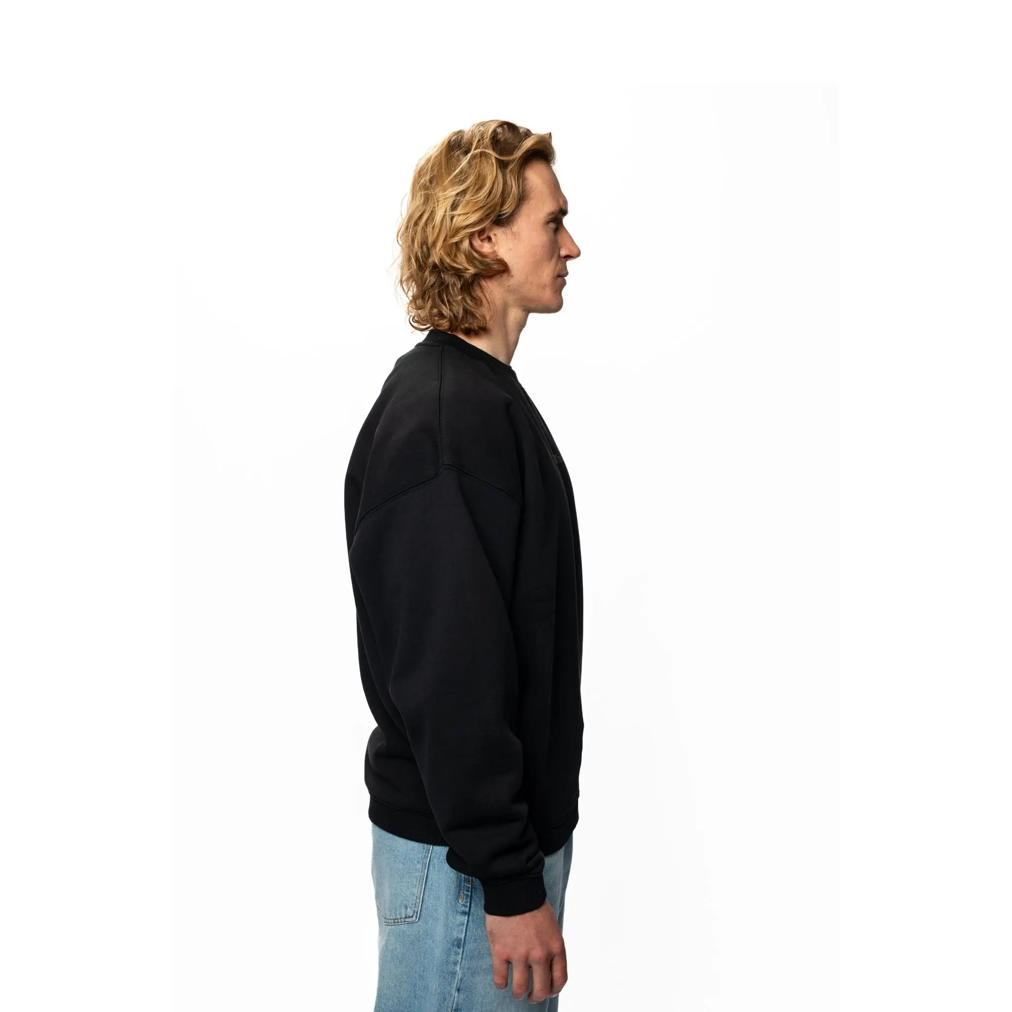 Person wearing a beige oversized t-shirt on a white background
