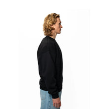 Person wearing a beige oversized t-shirt on a white background